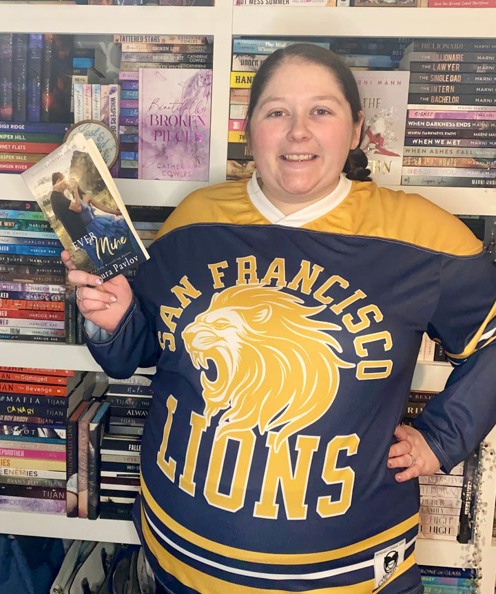 a woman in a hockey jersey holding a book