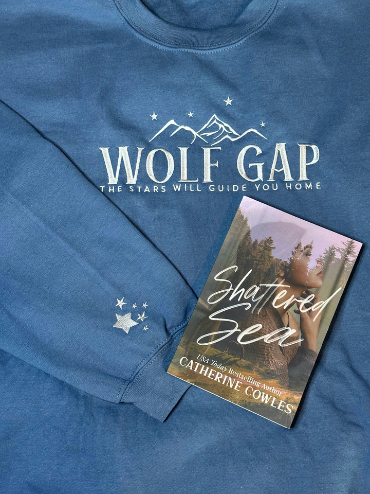 a book laying on top of a blue shirt